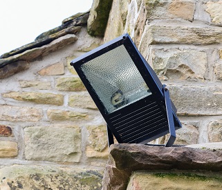 Home Security Light Mounted On The Corner Of A Rural Stone Cotta