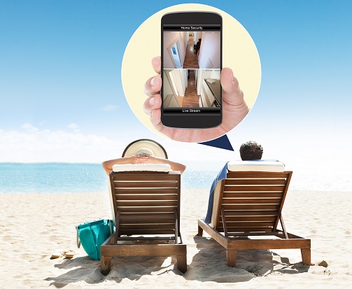 Couple Relaxing On Deck Chairs At Beach Resort