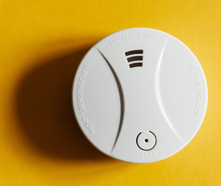 White Smoke Detector On Yellow Ceiling