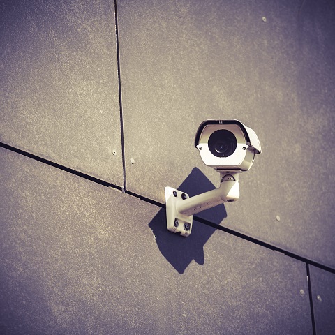 Security Camera On Gray Office Building Wall